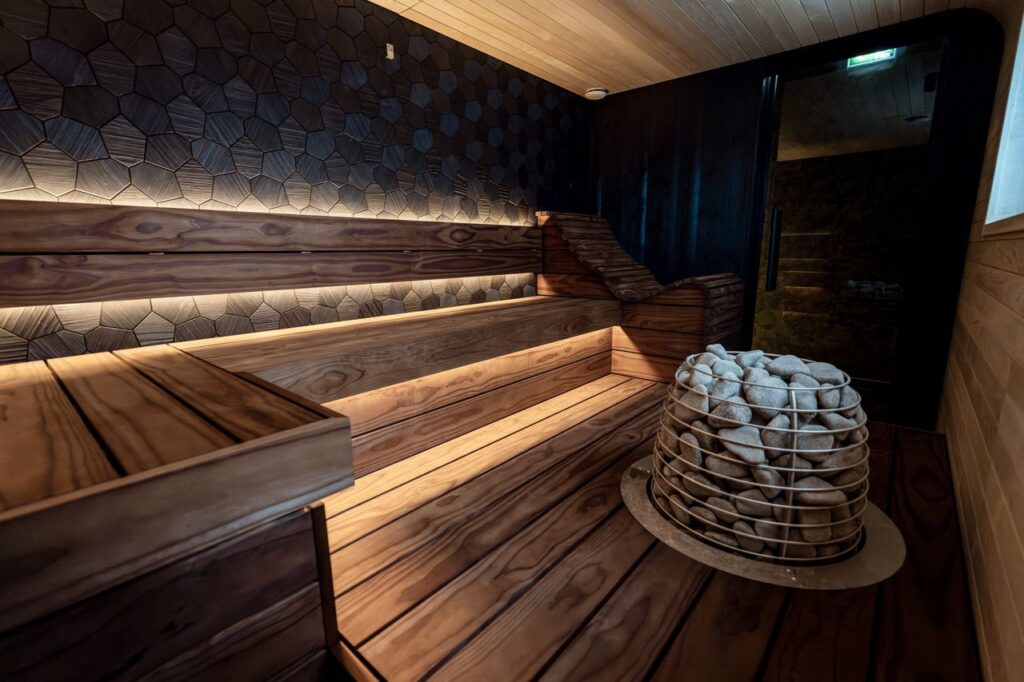 Stylish indoor sauna with wooden benches and modern LED lighting.