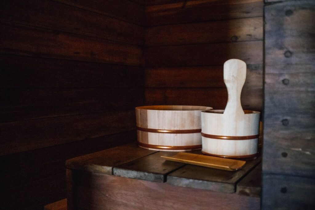 Warm and inviting wooden sauna interior with traditional wooden sauna buckets and ladle in Vancouver, Canada.
